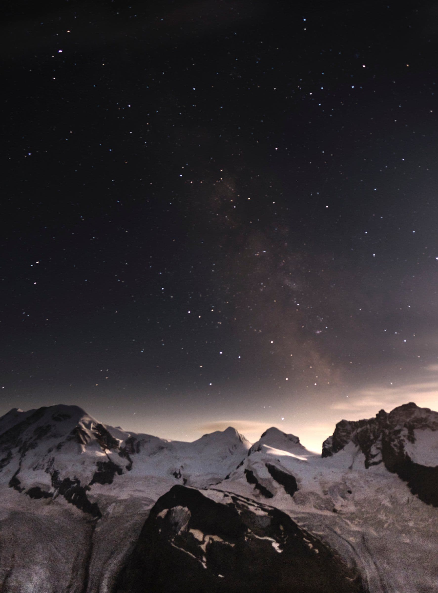 Snow peaks and a glacier under the Milky Way